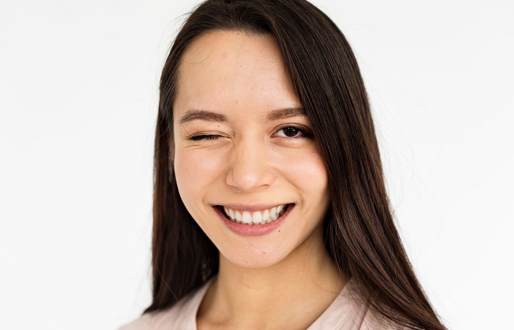 Studio portrait of an asian woman giving a wink