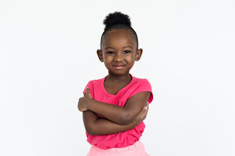 Cute little girl smiling awkwardly with her arms crossed