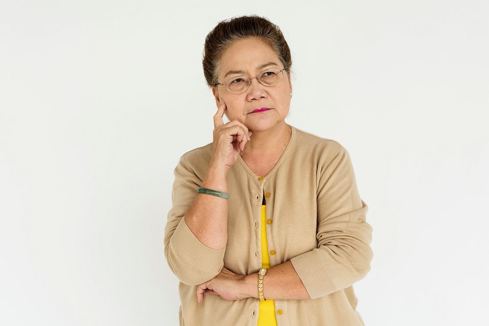 Studio portrait of a senior asian lady thinking