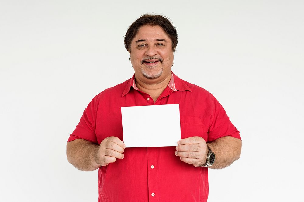 Studio portrait of a man holding a blank piece of paper