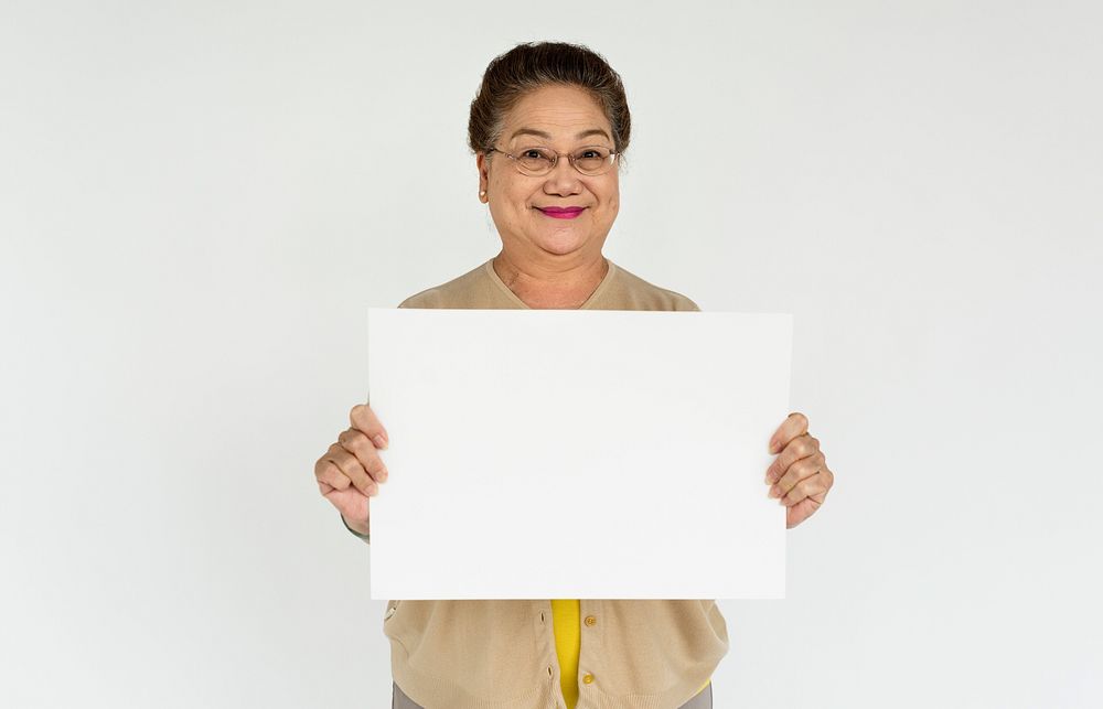 Studio portrait of an senior lady holding a blank placard