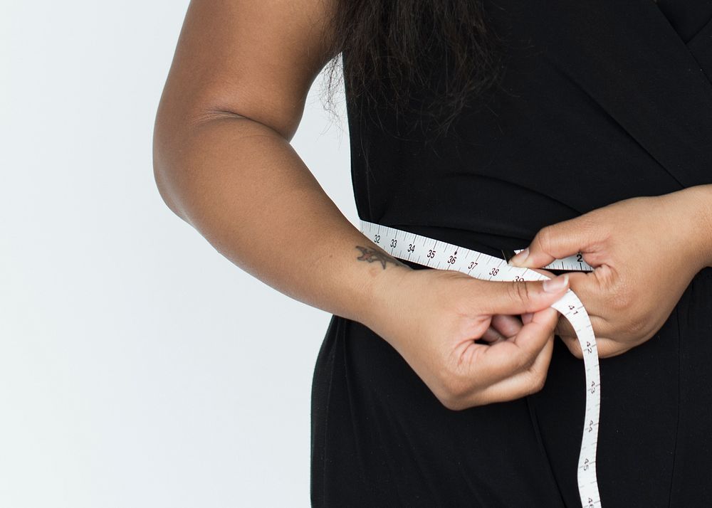 Close up of a woman measuring her waist