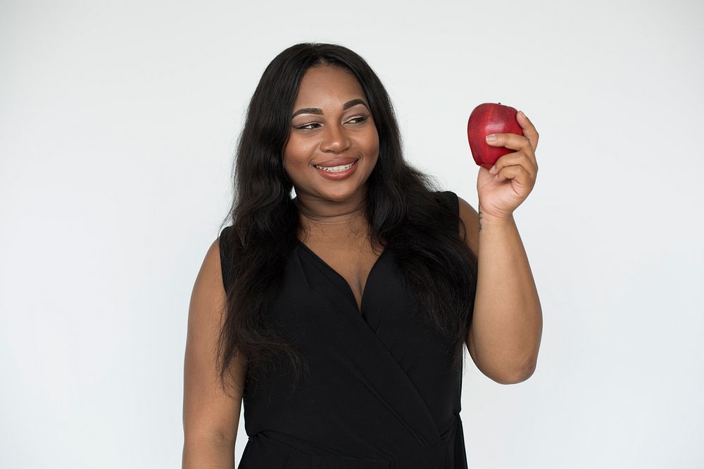 African American woman holding a red apple