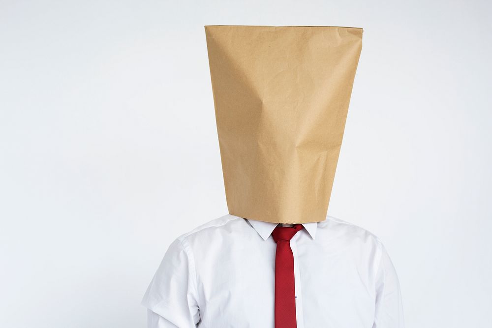 Anonymous man head covered with paper bag