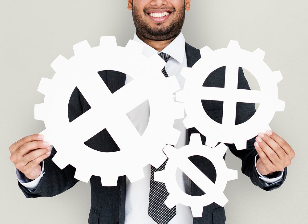 Businessman Smiling Happiness Holding Gear Symbol Concept