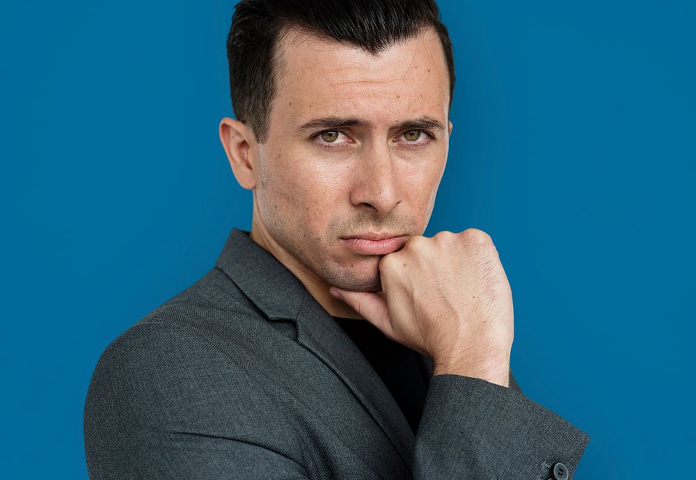 Studio portrait of a guy holding his chin