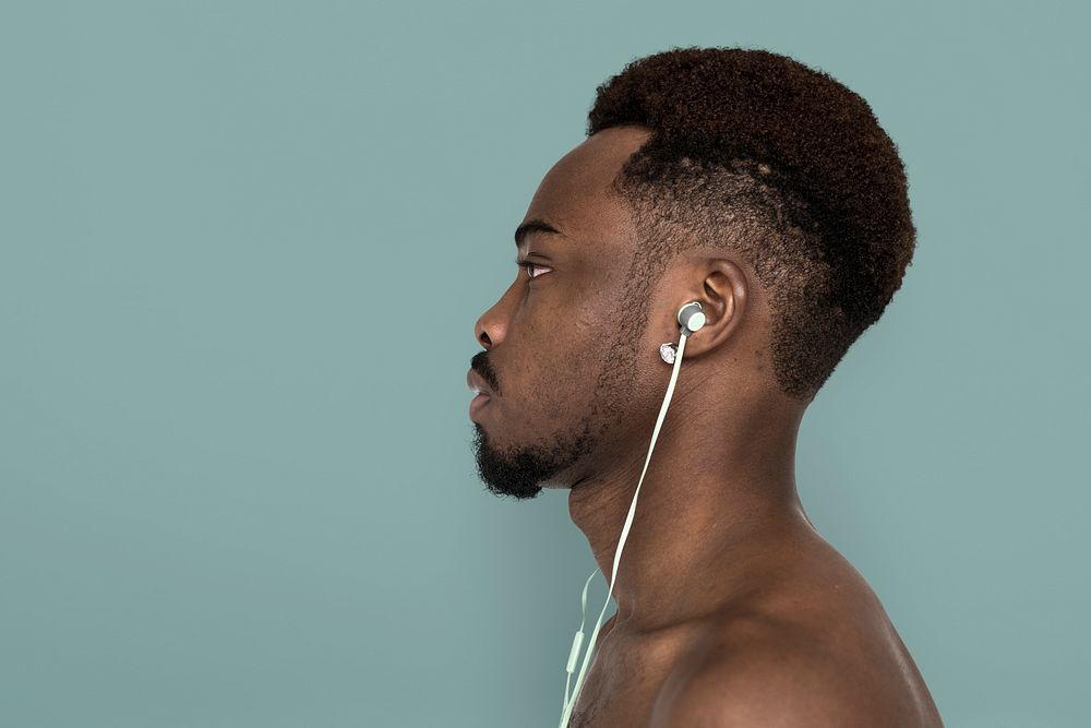 Studio profile of a man wearing earphones