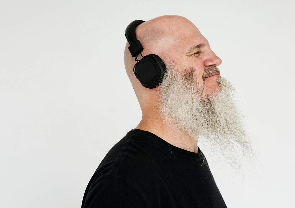 Portrait of a big bearded man listening to music