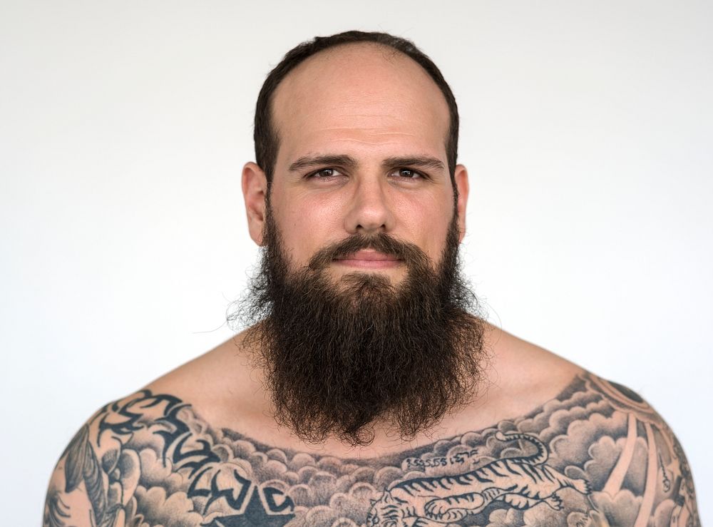 Portrait of a big tattooed bearded man