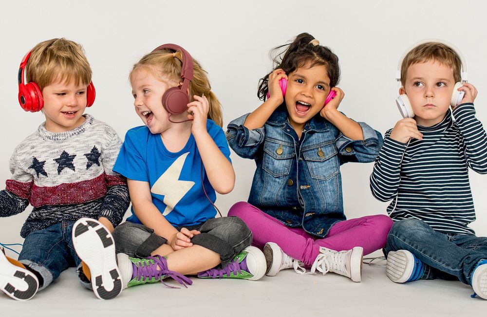 Cute small kids listening to music together