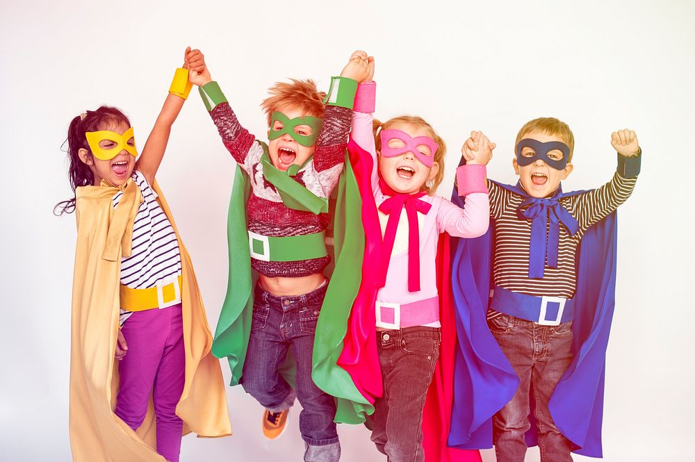 Superhero kids friends hands raised happiness together