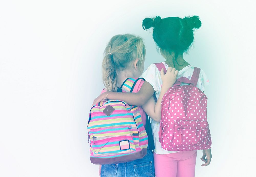 LIttle girls friends rear view with bag to go to school