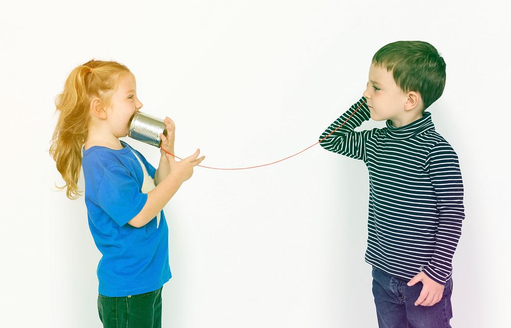 Little kids using string phone talking together