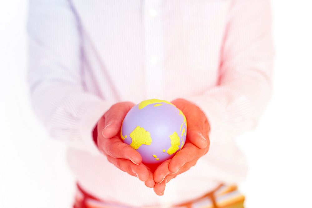 Hand holding fake globe for environment concept icon