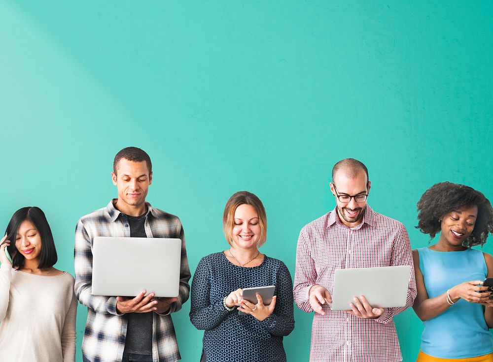 Diverse people with digital devices standing in a row