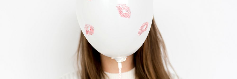 Balloon with kisses covering a girls face