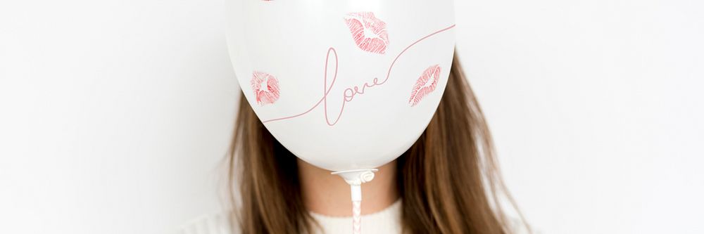 Balloon with kisses covering a girls face