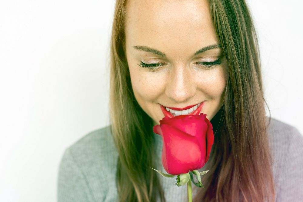 Woman smiling with rose romantic valentine