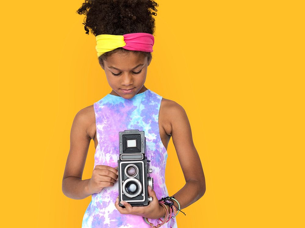 Little african girl holding camera