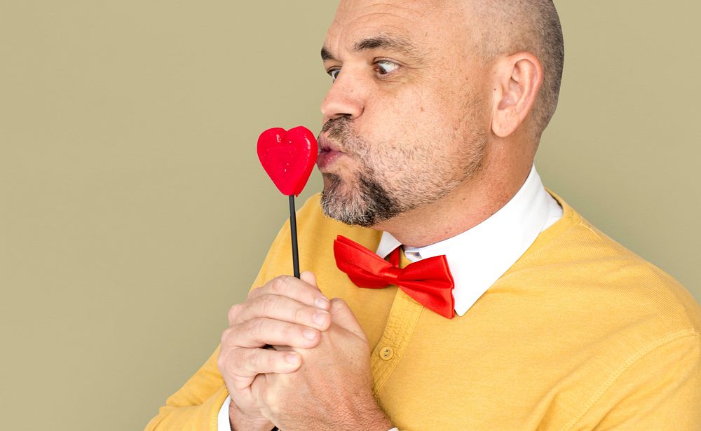 Caucasian Man Holding Heart Shape Lollipop