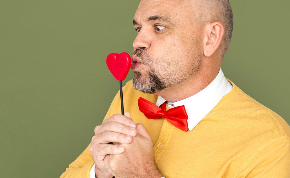 Caucasian Man Holding Heart Shape Lollipop