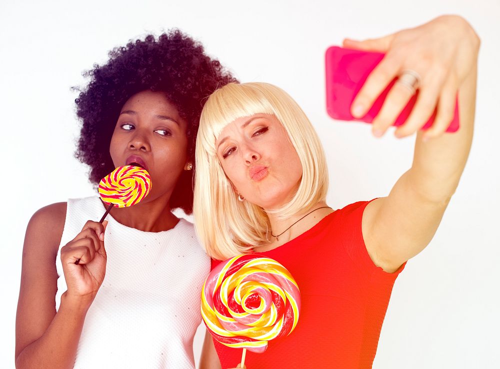 Girls friends take selfie on white background