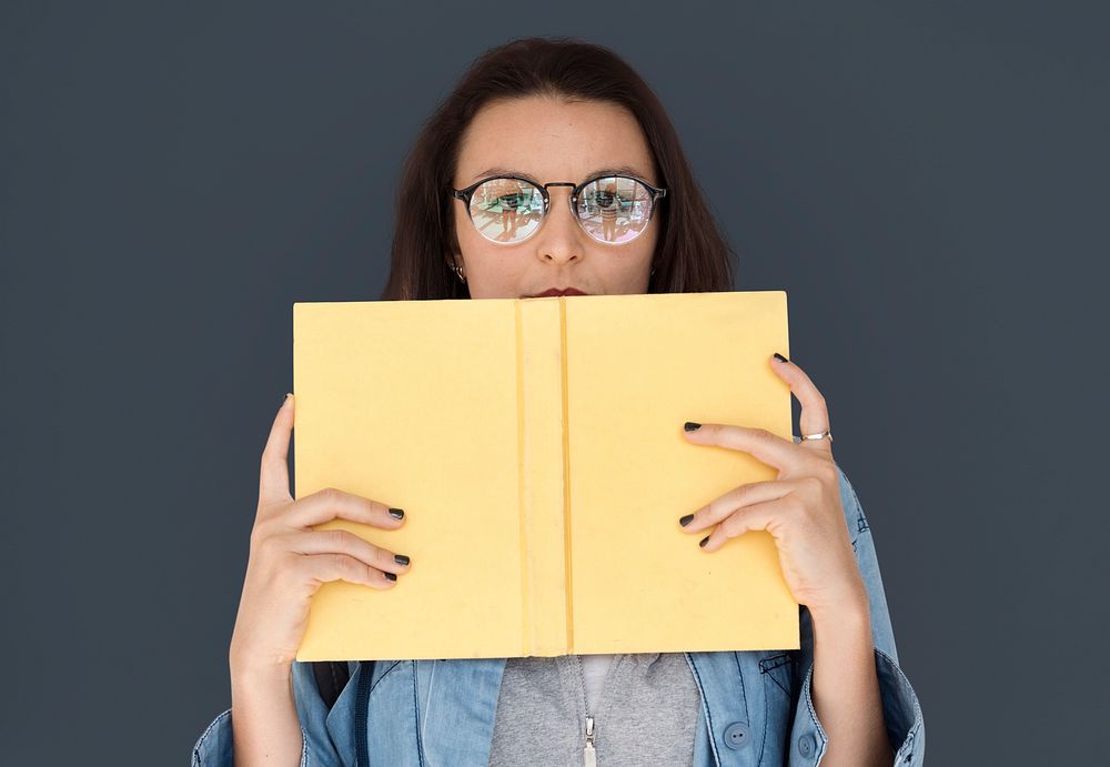 A girl with eyeglasses holding book