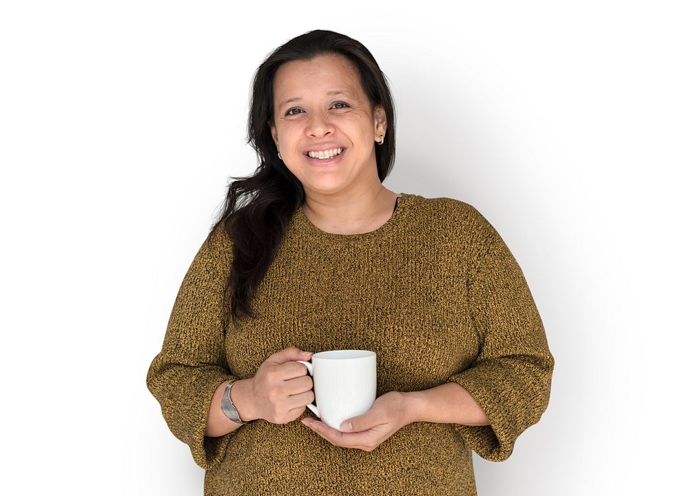 Woman is smiling holding coffee mug