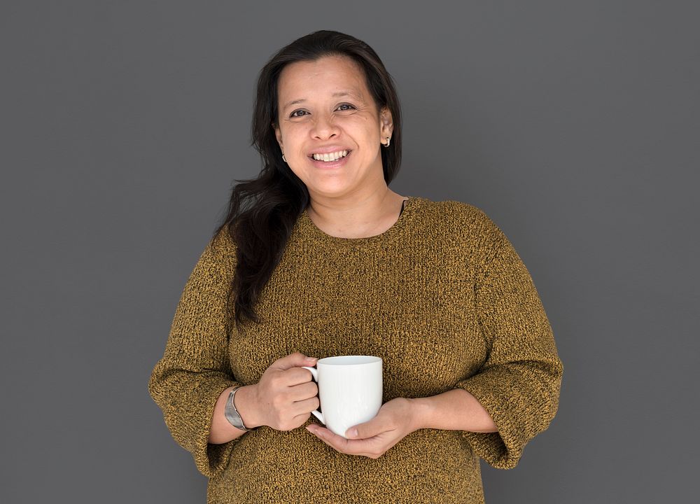 Woman is smiling holding coffee mug