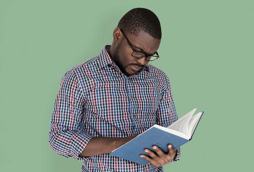 African descent man is reading a book