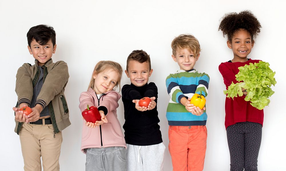 Kids holding vegetables