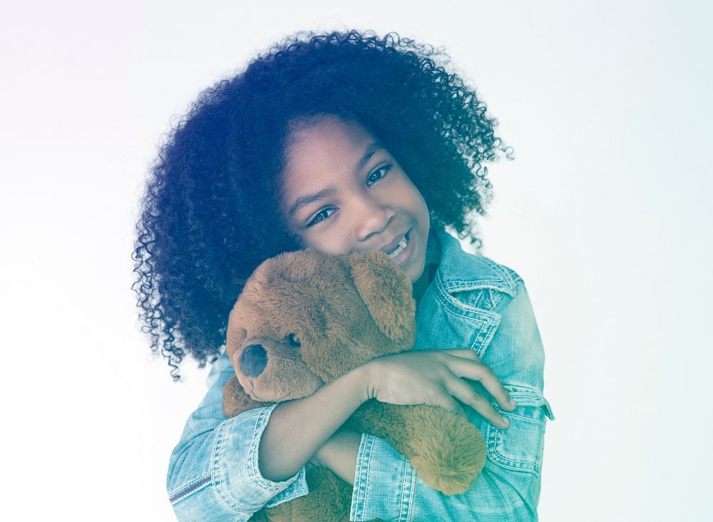 Young girl hudding teddy bear