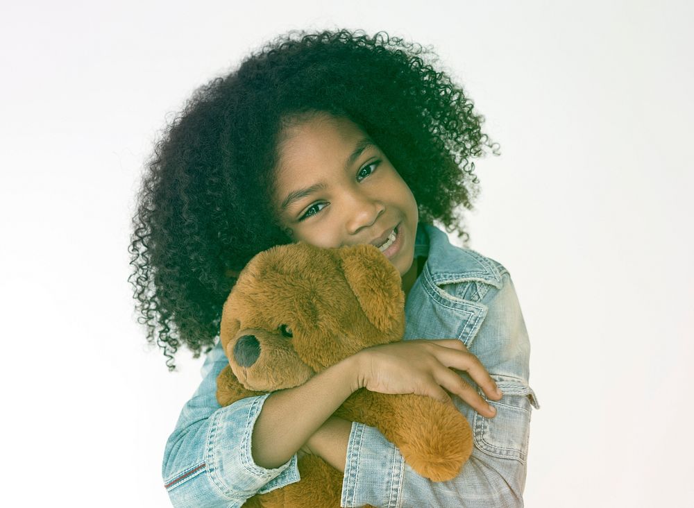 Young girl hudding teddy bear