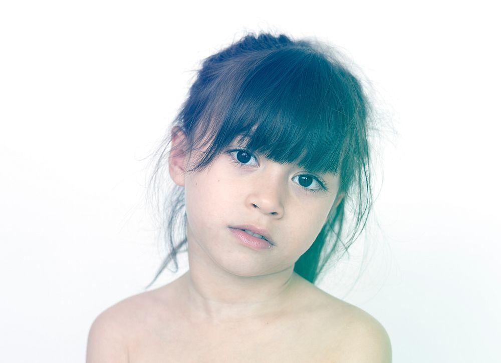 Young girl standing shirtless posing for picture