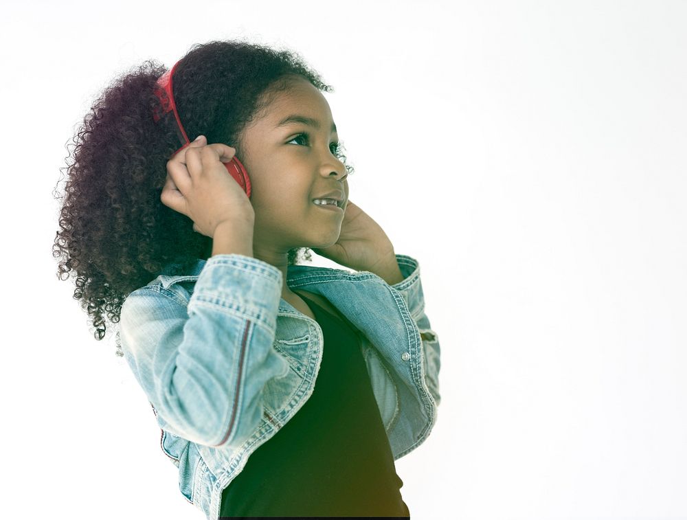Young girl listening to music using headphones