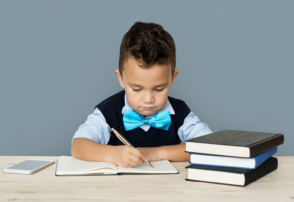 A Caucasian Boy Studying Writing Background Studio Portrait