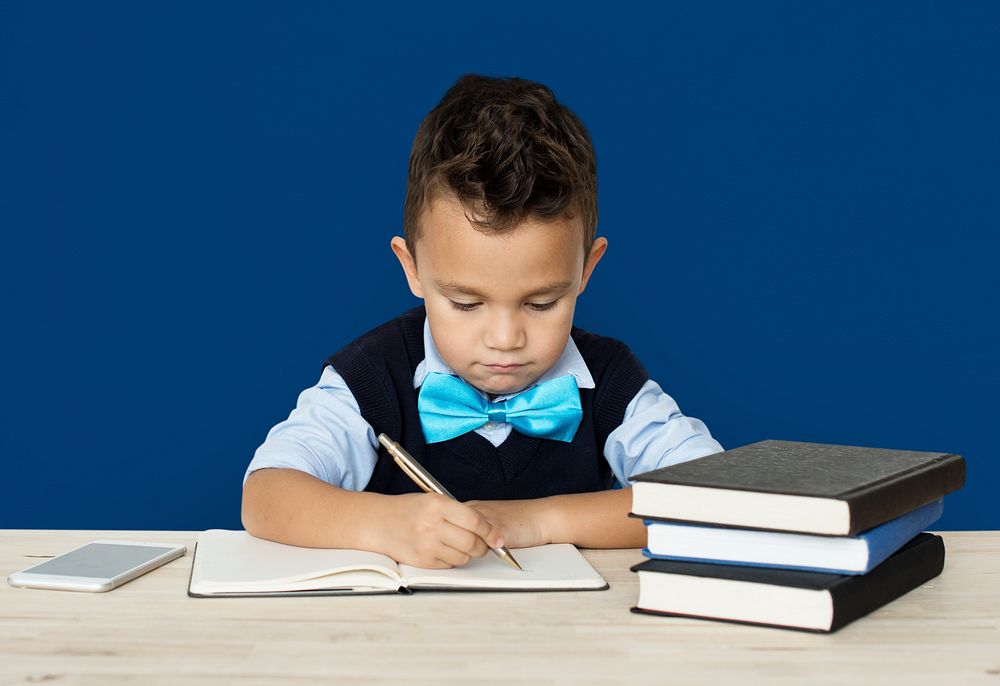 A Caucasian Boy Studying Writing Background Studio Portrait