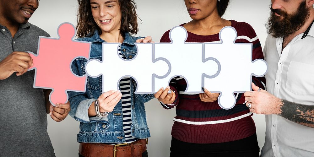 Group of People Holding Puzzle Pieces Concept