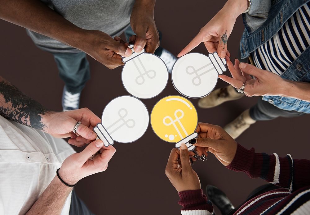 People Holding Paper Light Bulb Icon