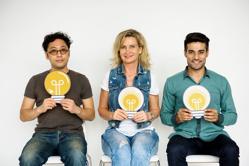 Group of People Holding Lightbulb Concept