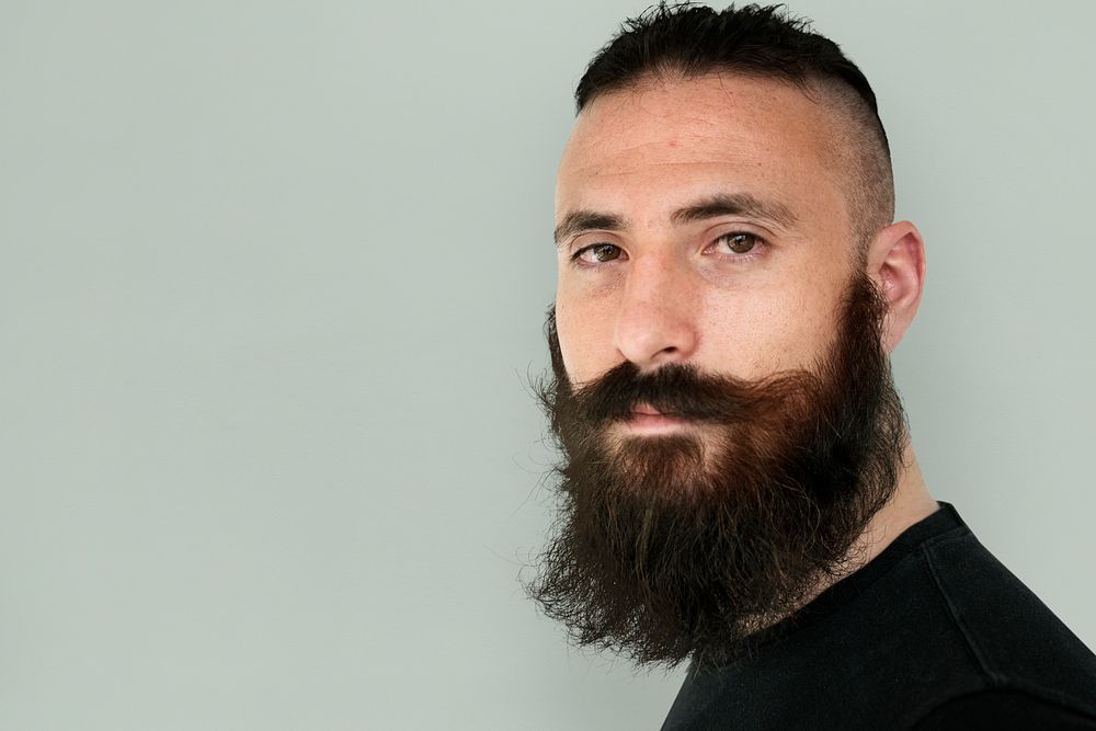 A man with beard and mustache in a studio shoot