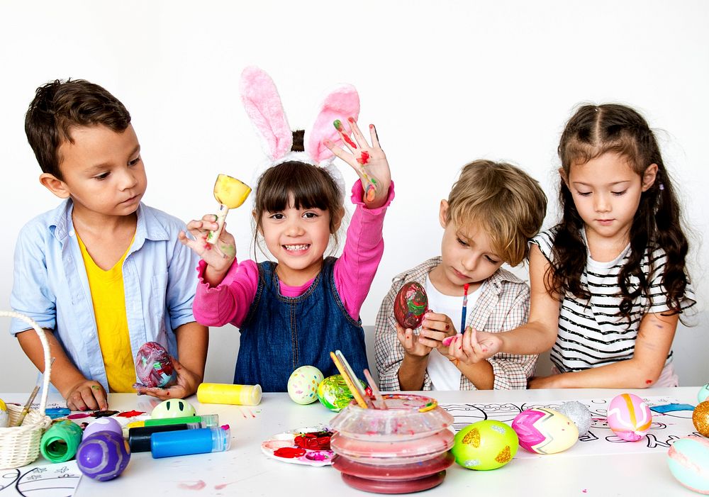 Group of kids painting Easter eggs