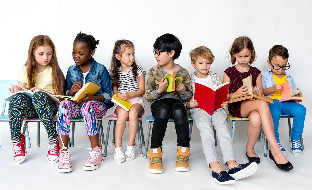 Group of students is sitting and reading a book.