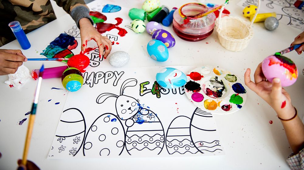 Messy table with an Easter coloring poster