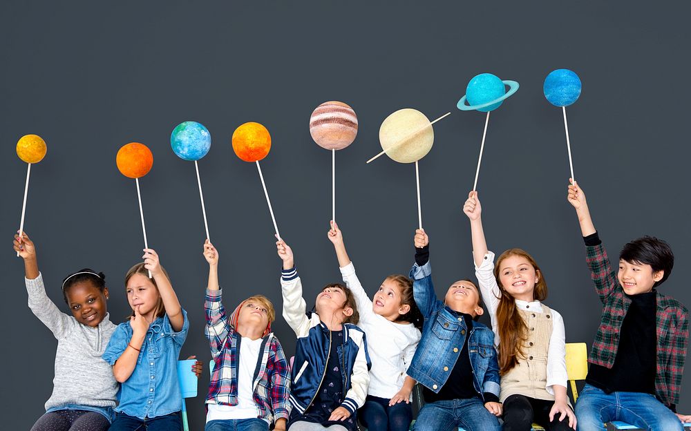 Happy Diverse group of kids holding planets