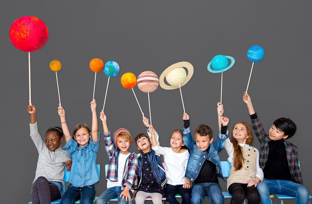 Happy Diverse group of kids holding planets