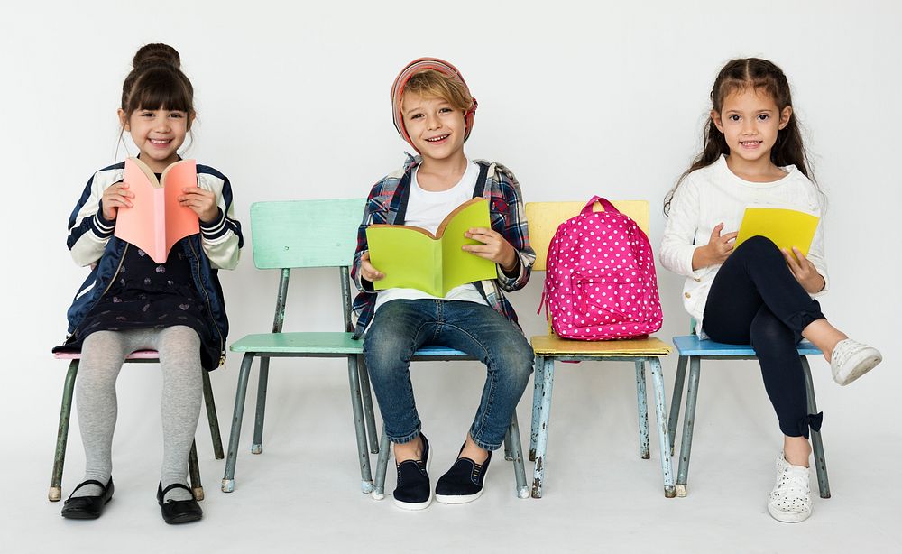 Group of Students Reading Book Sitting on the Chair