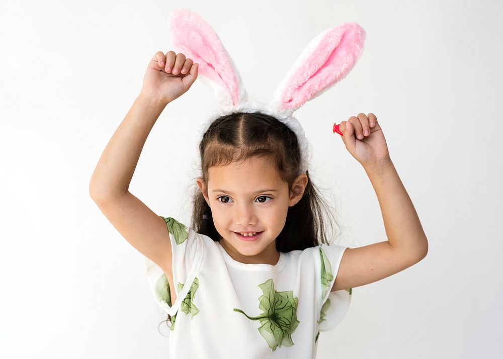 Little cute and adorable girl smiling with bunny headband studio portrait