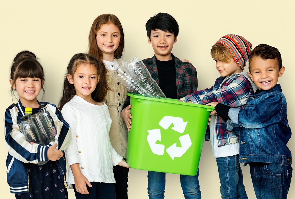 Kids and plastic bottles in a recycle bin