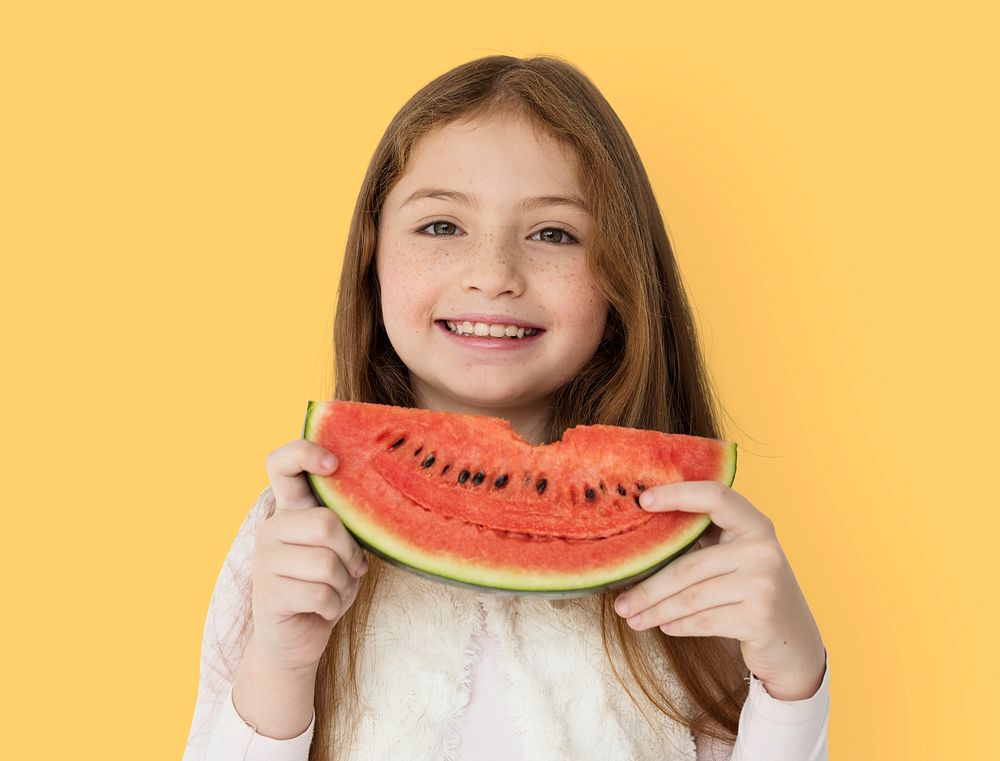 Young cheerful girl holding a slice of watermelon